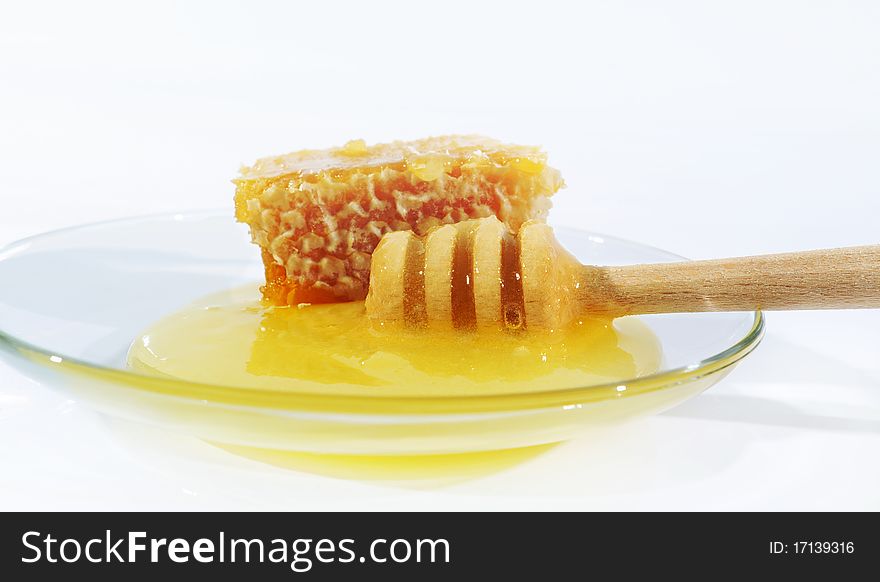 Sweet honey on the transparent plate. Sweet honey on the transparent plate.