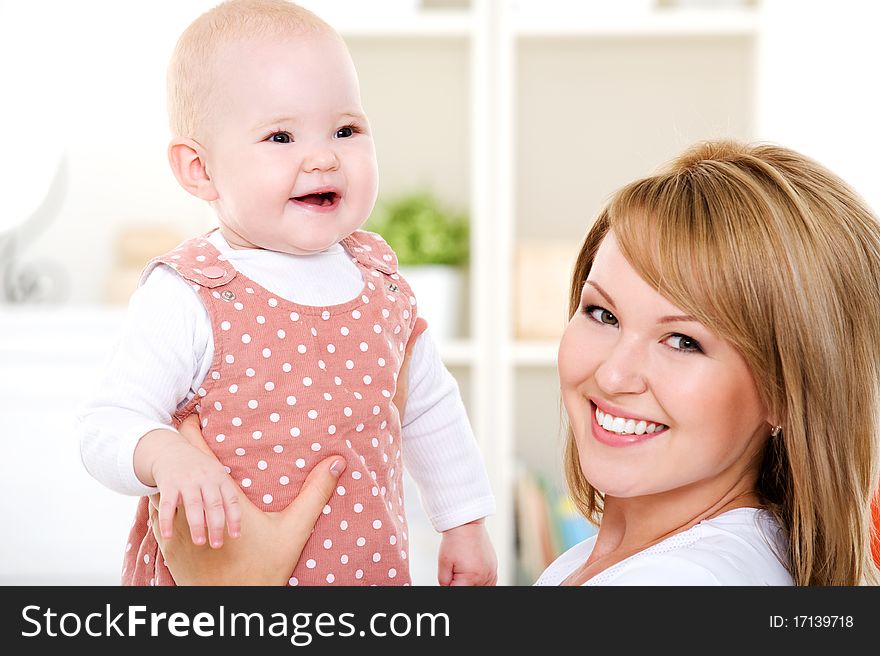 Closeup portrait of happy mother with newborn baby - indoors