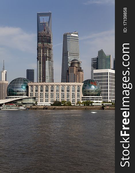 Shanghai / China: Construction site of the highest skyscraper in china at Shanghai's Pu - Lujiazui district with Huang Pu River in the foreground. Shanghai / China: Construction site of the highest skyscraper in china at Shanghai's Pu - Lujiazui district with Huang Pu River in the foreground.