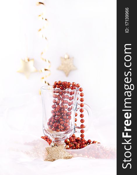 Golden christmas stars and red bow in the glass over white. Golden christmas stars and red bow in the glass over white