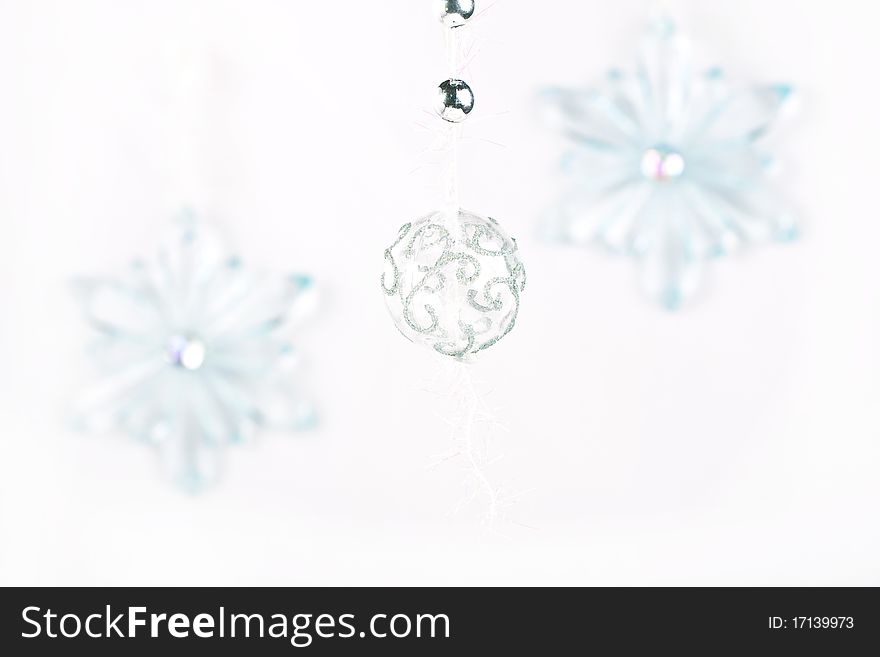 Silver christmas ball and transparent snowflakes over white background. Silver christmas ball and transparent snowflakes over white background