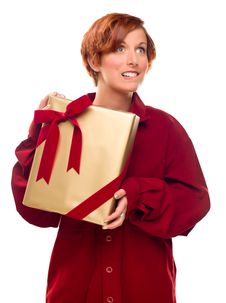 Pretty Girl Biting Lip Holding Wrapped Gift Royalty Free Stock Image