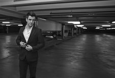 Businessman Getting Out Of A Car In A Parking Lot Stock Image Businessman Getting Out Of A Car In A Parking Lot Stock Image