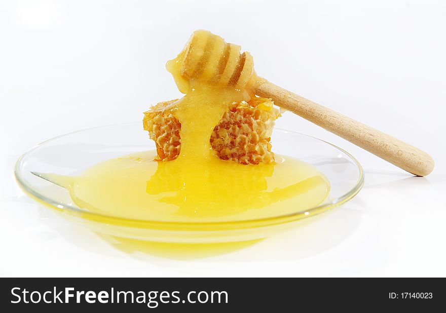 Horizontal photo with sweet honey on the transparent plate. Horizontal photo with sweet honey on the transparent plate.
