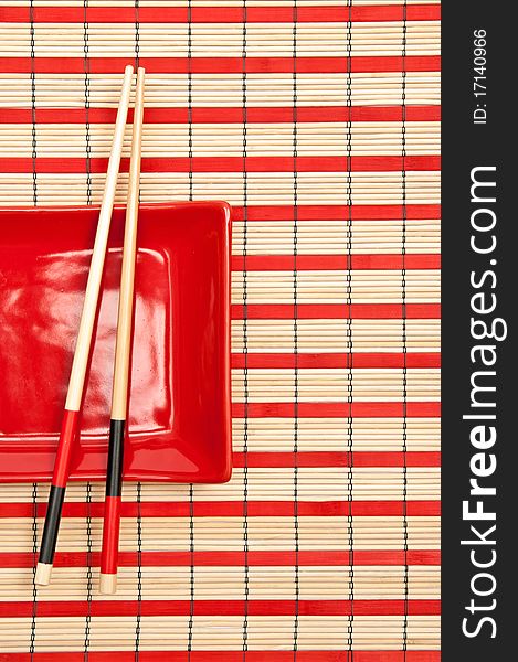 Close up of red and black sushi set on the bamboo background