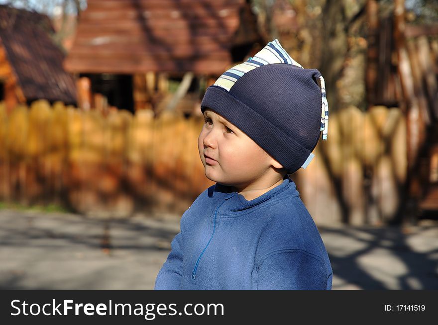 Little boy standing in front of a playground. Little boy standing in front of a playground