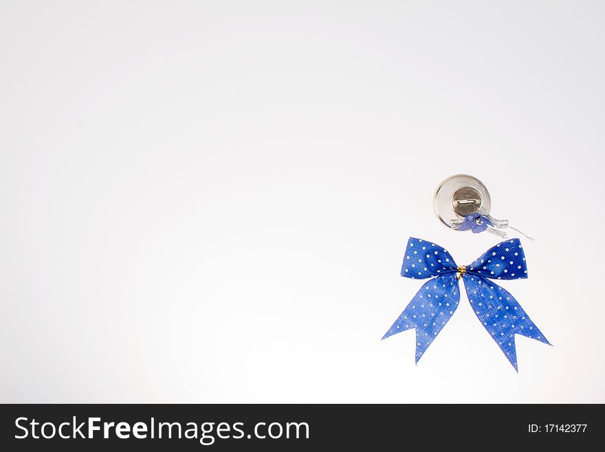 Christmas bell and blue bow on white background