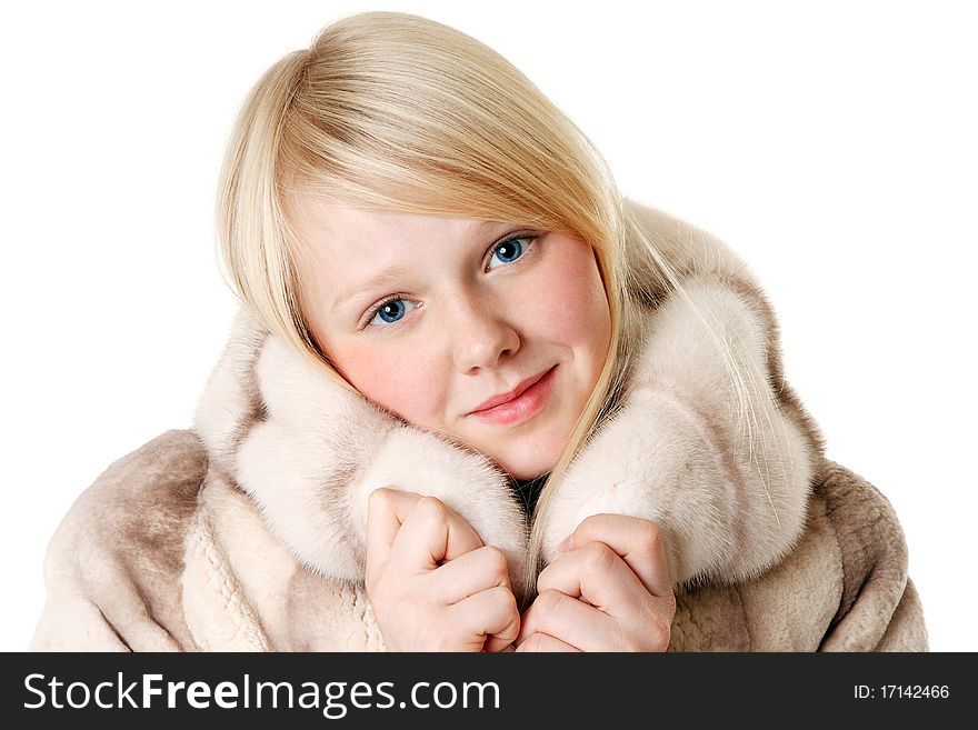 Blonde girl with blue eyes wearing a fur coat