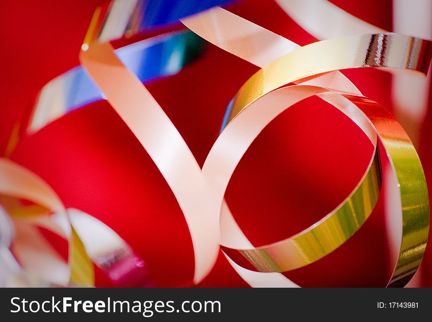 Golden christmas-tree tinsel over red. Abstract, bokeh. Golden christmas-tree tinsel over red. Abstract, bokeh