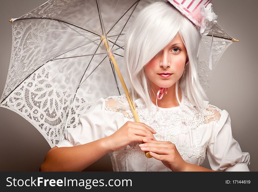 Pretty White Haired Woman Wearing Classic Dress with Parasol and Small Top Hat. Pretty White Haired Woman Wearing Classic Dress with Parasol and Small Top Hat.