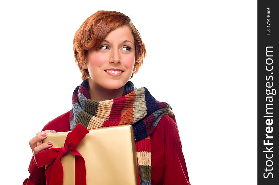 Pretty Red Haired Girl with Scarf Holding Wrapped Gift Looking Off to the Side Isolated on a White Background. Pretty Red Haired Girl with Scarf Holding Wrapped Gift Looking Off to the Side Isolated on a White Background.