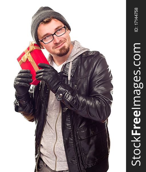 Curious Young Man Holding Wrapped Gift To His Ear