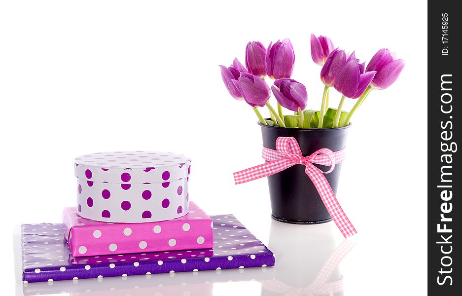 Purple tulips and colorful gifts with dots isolated over white. Purple tulips and colorful gifts with dots isolated over white