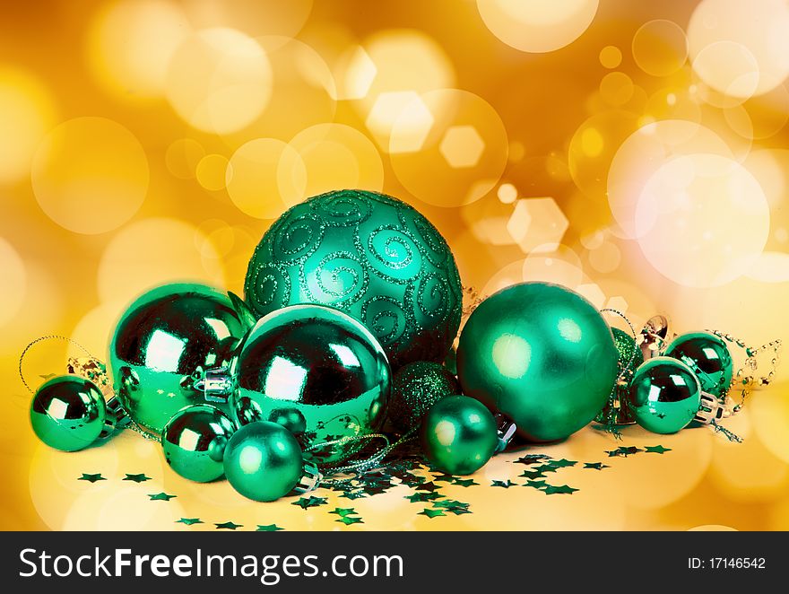 Green baubles with blurred lights in the background