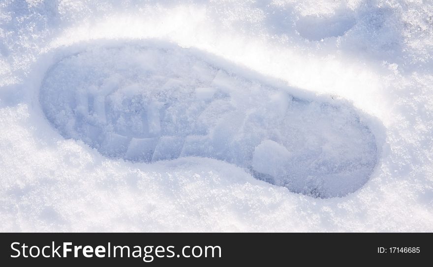 A shoe foot step in the winter snow. A shoe foot step in the winter snow