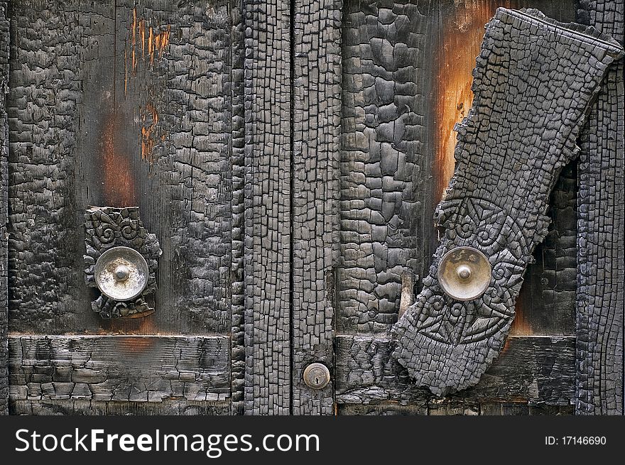 Detail of a burned door. Detail of a burned door