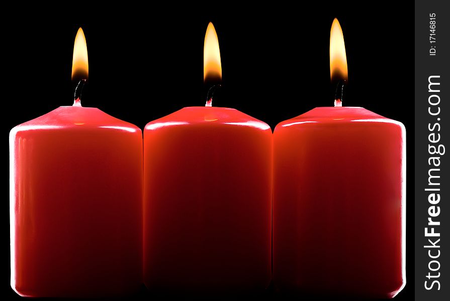 Three red burning candles over black. Three red burning candles over black