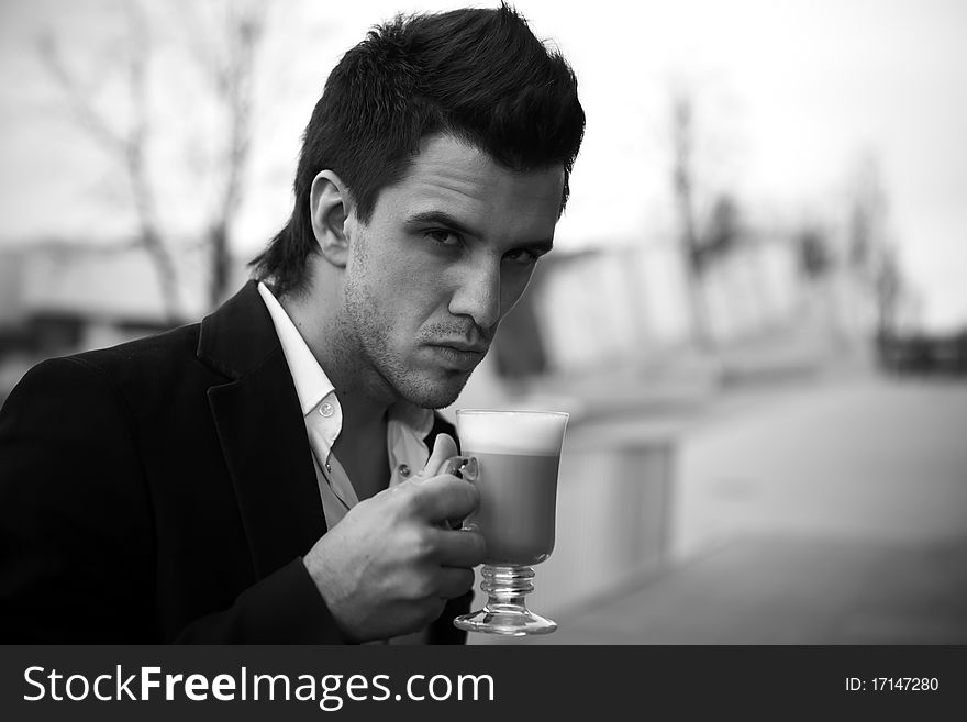 Portrait of Young attractive businessman drinking coffee