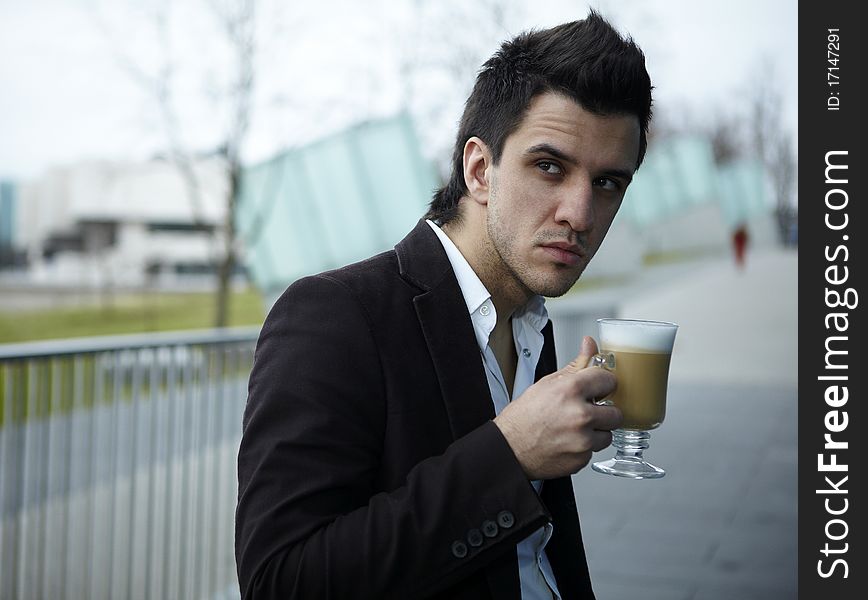 Portrait of Young attractive businessman drinking coffee