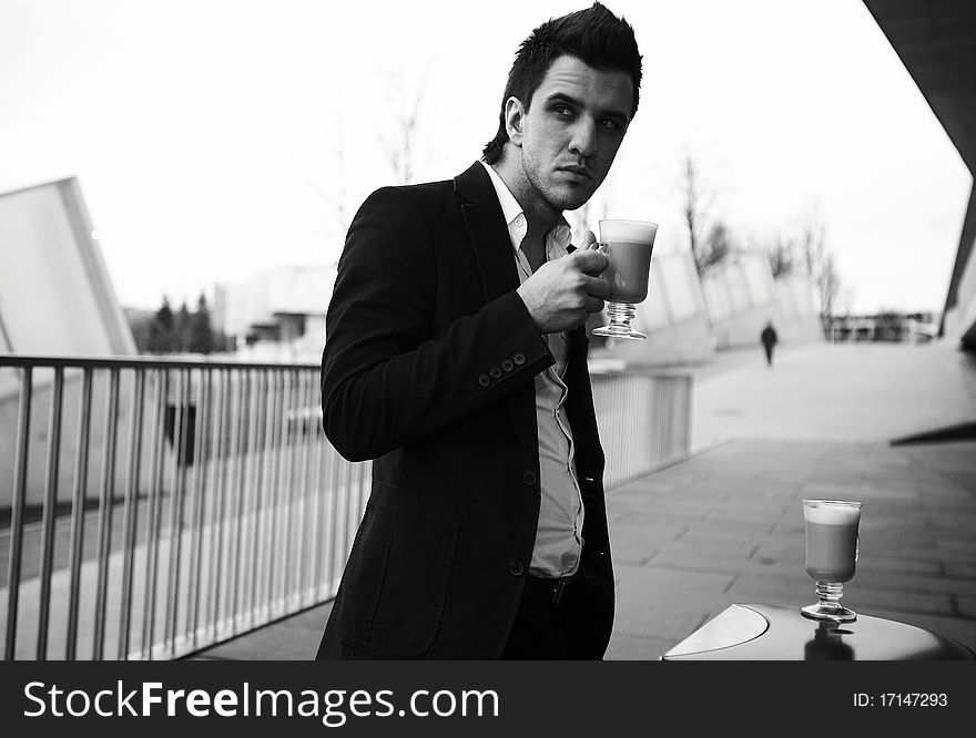 Portrait of Young attractive businessman drinking coffee