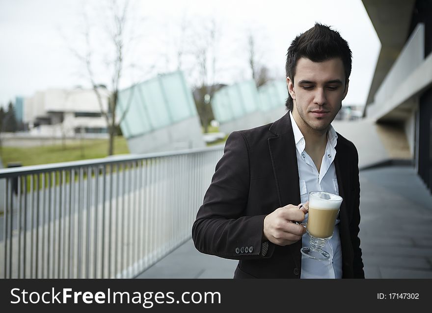 Portrait of Young attractive businessman drinking coffee