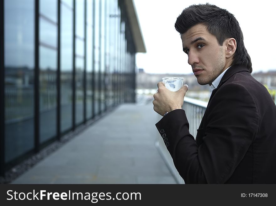 Portrait of Young attractive businessman drinking coffee