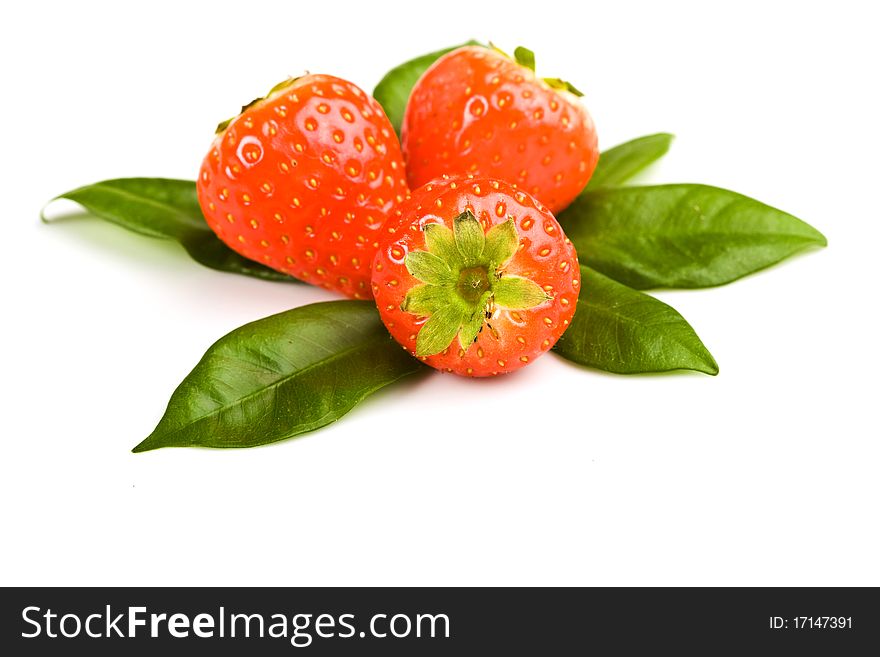Photo of strawberries on green foils putted on white isolated background. Photo of strawberries on green foils putted on white isolated background