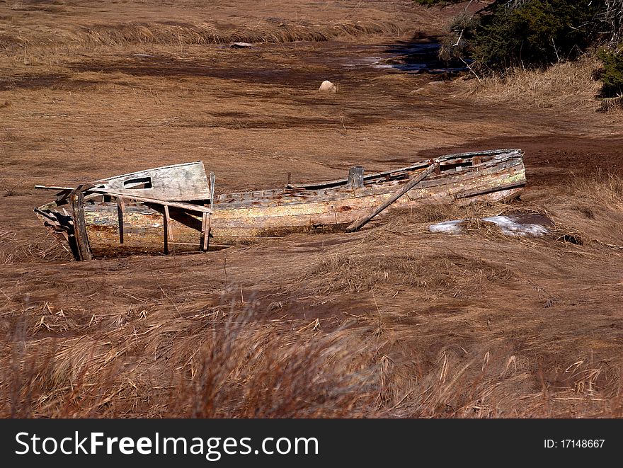 A fishing boat beached on a coastal inlet. A fishing boat beached on a coastal inlet