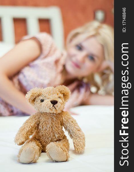 Beautiful young girl with bear toy in bed. Beautiful young girl with bear toy in bed