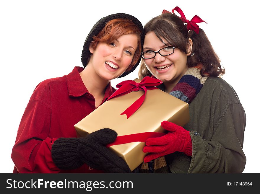 Two Pretty Girlfriends Holding A Holiday Gift Isolated on a White Background.