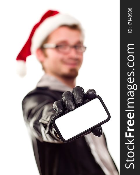 Smiling Young Man with Santa Hat Holding Out Blank Cell Phone Isolated on a White Background.