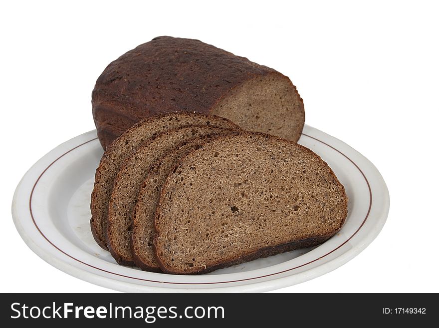 Fresh rye-wheat bread on a plate in isolated on white. Fresh rye-wheat bread on a plate in isolated on white