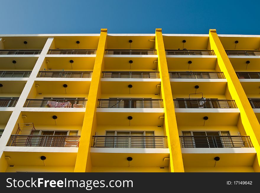 Yellow and white building and blue sky, Thailand.