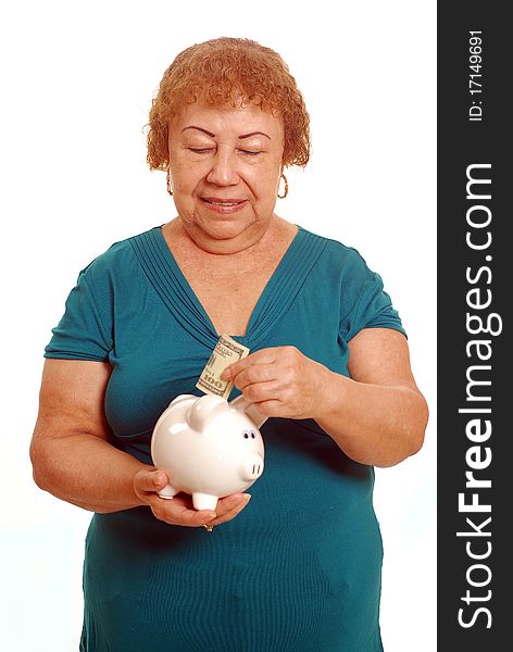 Hispanic female senior with piggy bank. Hispanic female senior with piggy bank