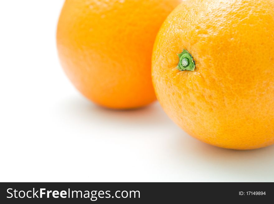 Two fresh oranges closeup on white background