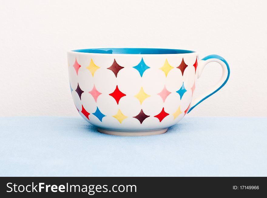 Colorful cup on blue cloth, Thailand.