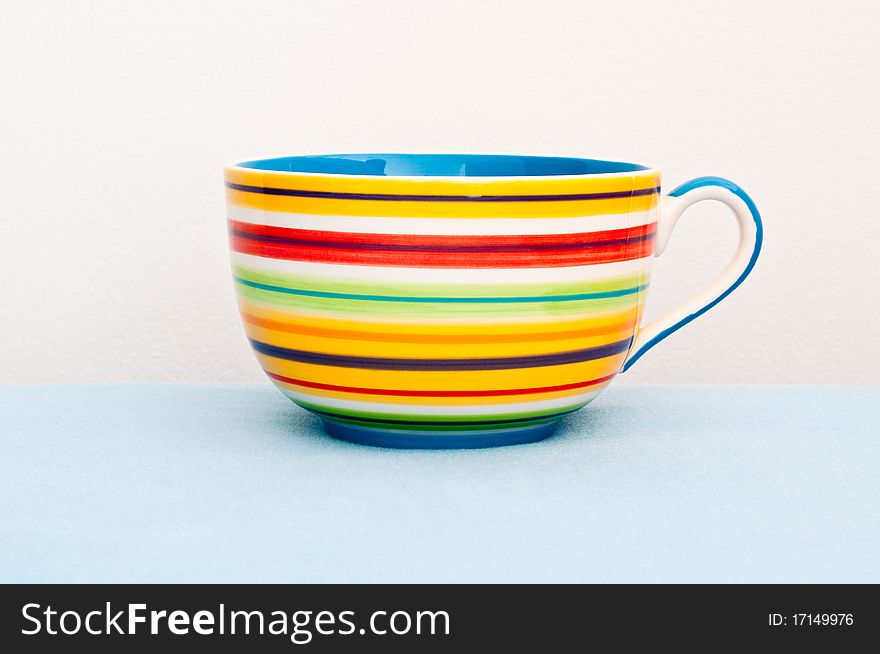 Colorful Cup On Blue Cloth