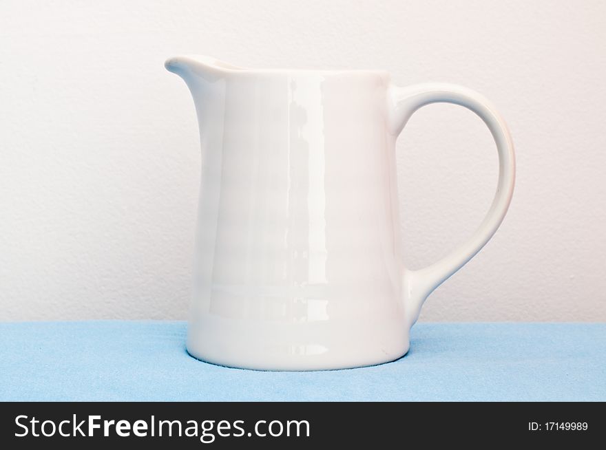 White Cup On Blue Cloth