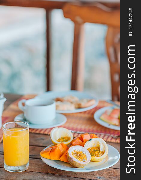 Tasty Exotic Fruits - Ripe Passion Fruit, Mango On Breakfast At Outdoor Restaraunt