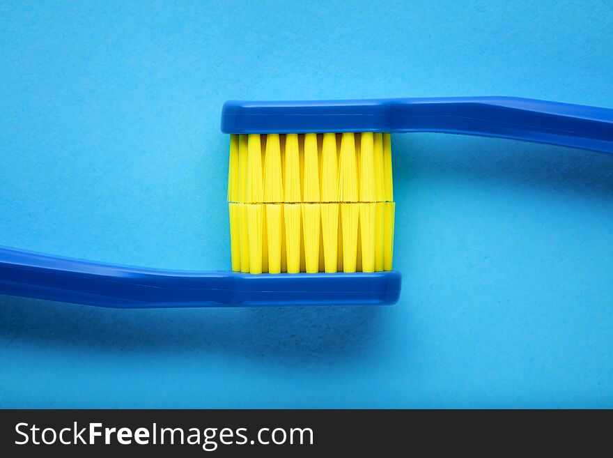 Toothbrushes displaying the stained teeth on blue background. Concept of  brushing teeth for dental hygiene or teeth stain