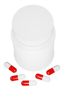 Capsule Pills And White Plastic Bottle. Royalty Free Stock Images