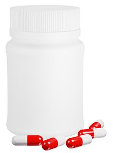 Capsule Pills And White Plastic Bottle. Royalty Free Stock Images