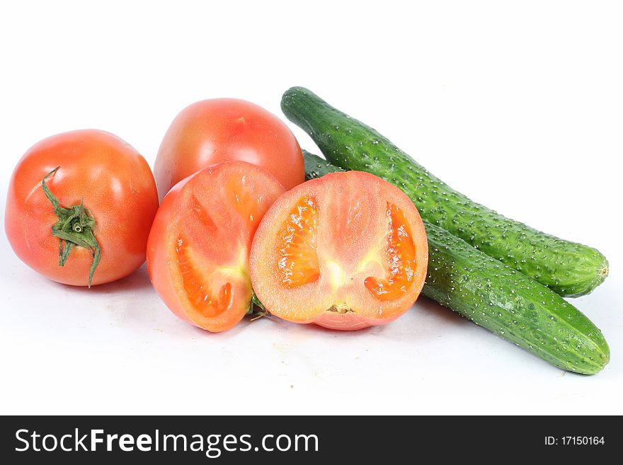 Tomatoes and cucumber on white background