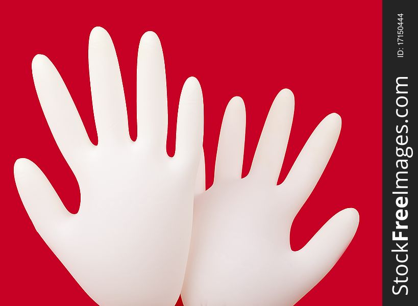 Medical gloves on red background