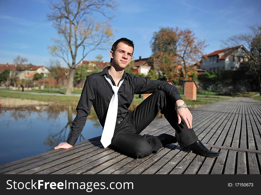 Portrait with attractive young man on a pontoon. Portrait with attractive young man on a pontoon