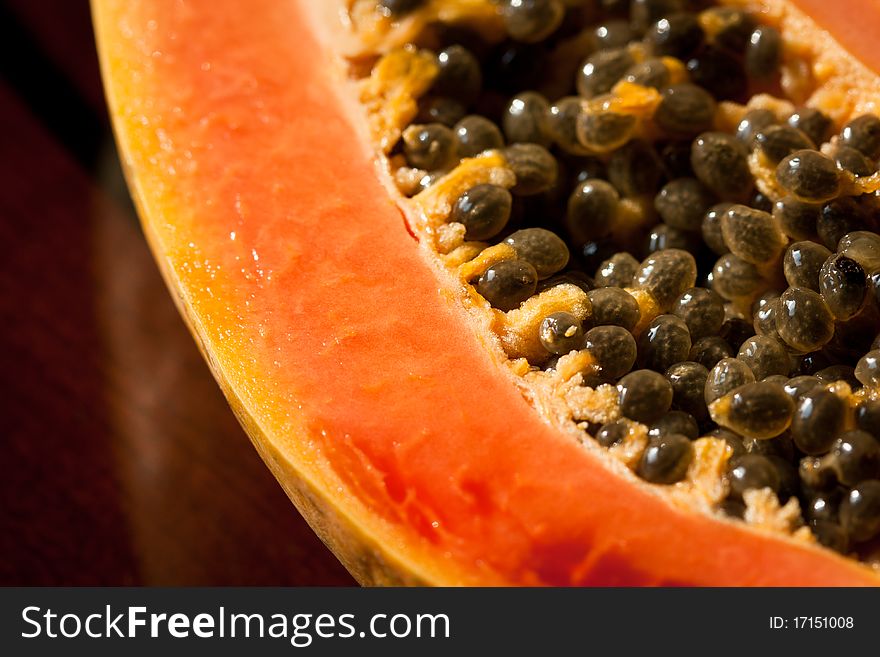 A close-up image of a papaya and its seeds. A close-up image of a papaya and its seeds