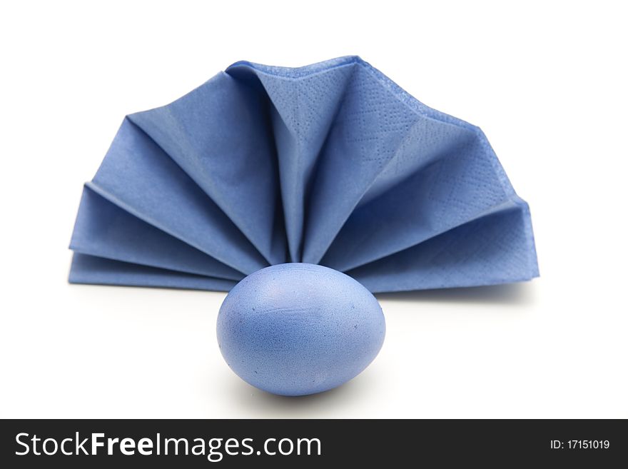 Blue Easter egg before bluer folded napkin. Blue Easter egg before bluer folded napkin