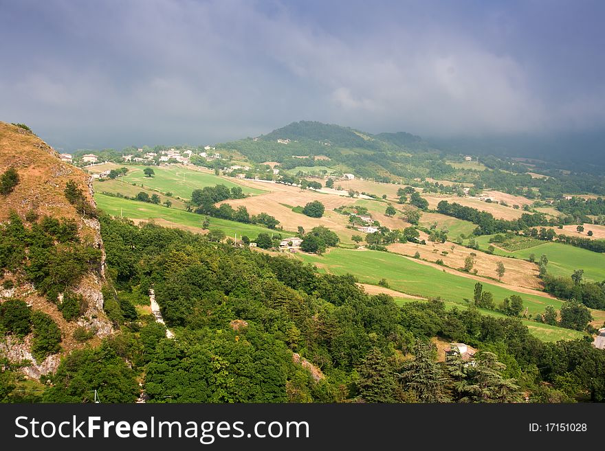 Hilly countryside of le Marche, Italy, with rainy sky