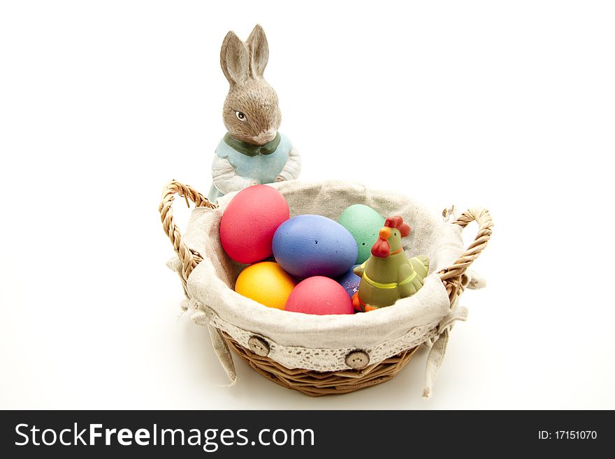 Colored eggs in the basket with Easter bunny