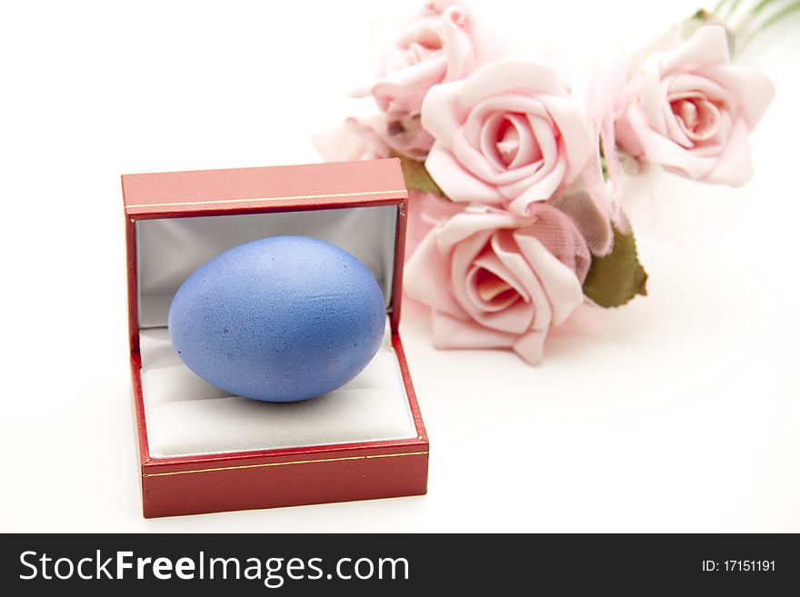 Blue Easter egg in the etui with roses